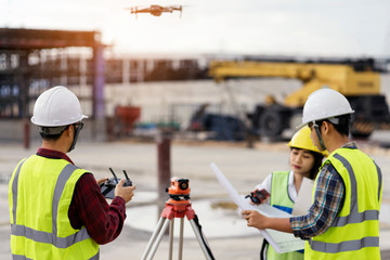 civil engineering flying drone over construction site survey for land and building project. - obrazy, fototapety, plakaty