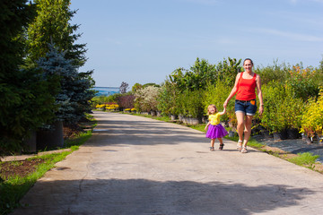 Mother and daughter walking in a park