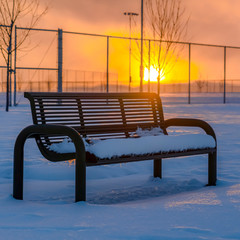 Bench against sunset on a winter day in Utah
