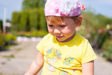 Little girl walking in a sunny park