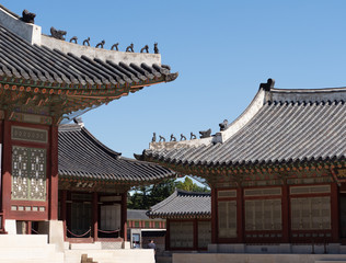 Naklejka premium Gyeongbokgung Palace Buildings with Decorative Tiles and Statues