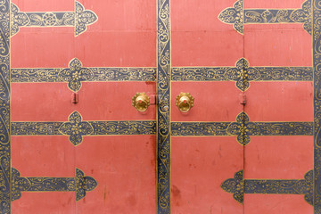 door knocker on the red door.The Chinese character on the door knockers means  