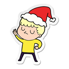 sticker cartoon of a grumpy boy wearing santa hat