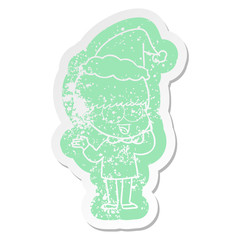 happy cartoon distressed sticker of a boy wearing santa hat