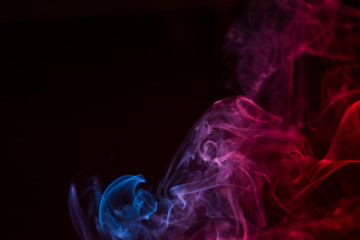 Fototapeta premium Colorful smoke close-up on a black background