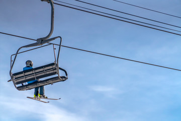 Chair lift with a person in Park City ski resort