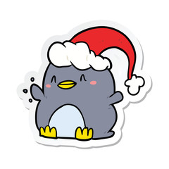 sticker of a cartoon penguin wearing christmas hat