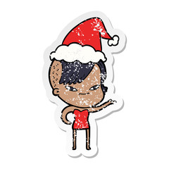 cute distressed sticker cartoon of a girl with hipster haircut wearing santa hat