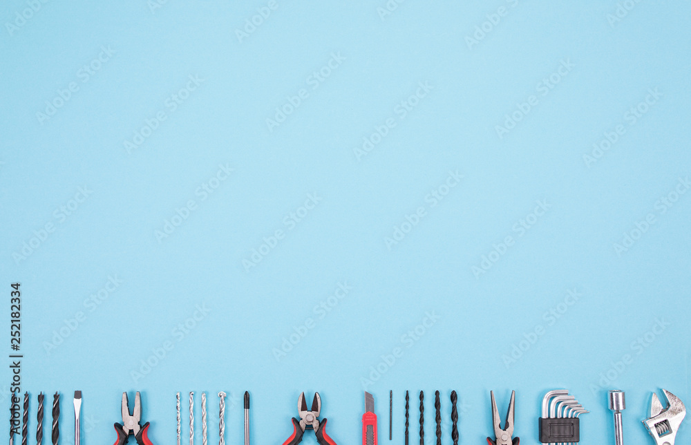 Wall mural Set of different tools on blue background