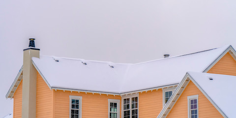 Daybreak home with snow covered roof in winter