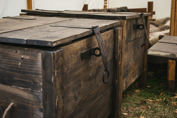 Detail of big old wooden chests covered with lids. Medieval reconstruction