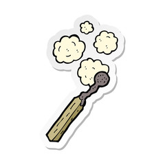 sticker of a cartoon burnt match