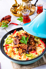 Tajin with couscous, vegetables and meat on white background
