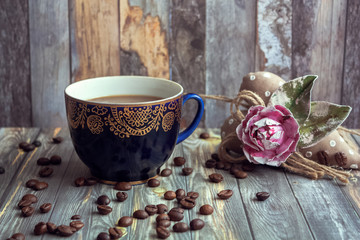 cup of tea with flowers on wooden background