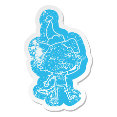 cartoon distressed sticker of a dog sticking out tongue wearing santa hat