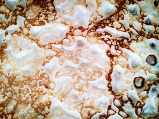 Fototapeta na wymiar Texture baked homemade pancakes with a beautiful pattern close up