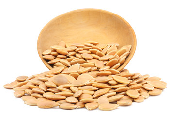 Pumpkin seeds in a cup isolated on white background