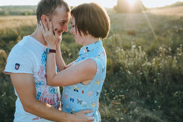 Young beautiful couple walking outside on beautiful sunset