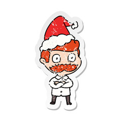 distressed sticker cartoon of a man with mustache shocked wearing santa hat