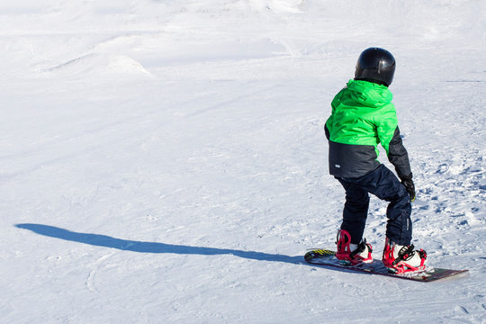 Kid On Snowboard In Winter Sunset Nature. Sport Photo With Edit Space