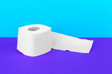 Toilet paper isolated on white table with blue background. Cleaning concept product