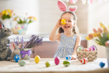 Girl with painted eggs