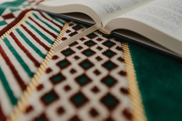 Islamic concept - The holy Quran on a praying matt - Image