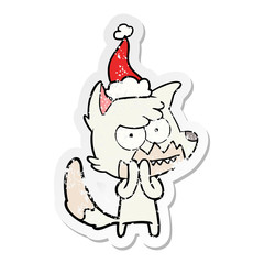 distressed sticker cartoon of a grinning fox wearing santa hat