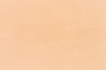 background to the old wall beige paint flaked, close-up