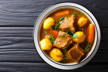 Tasty organic african lamb stew with vegetables close-up in a bowl. horizontal top view