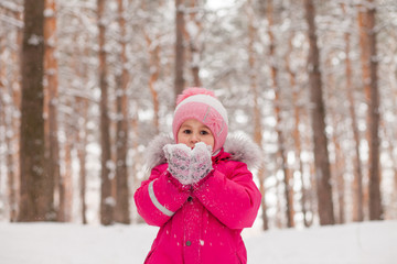 Small girl playing with snow