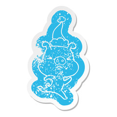 cartoon distressed sticker of a annoyed pig running wearing santa hat
