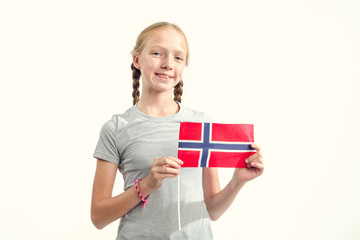 Portrait of a teenager girl with the flag of Norway on a light background. Scandinavian people.