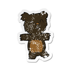 retro distressed sticker of a cartoon cute black bear cub