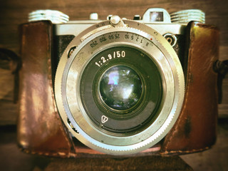 An old mechanical film camera, a background of wood
