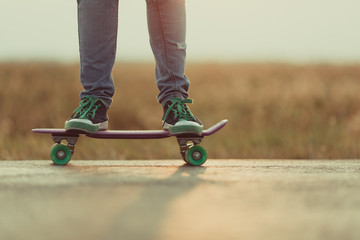 Young happy cute girl rides skateboard on road, outdoor © rimmdream