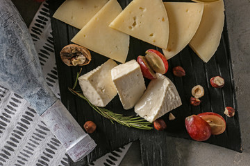 Assortment of tasty cheese on board