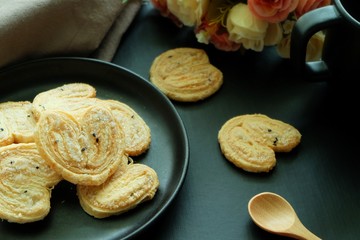 Butterfly cookies on black plate and black background. 
