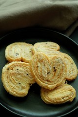 Butterfly cookies on black plate and black background. 