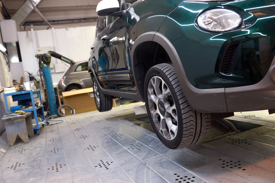  Italy, Desio, 26 october, 2018, Car technician repairing car in workshop service station,  Italy, Desio, 26 october, 2018