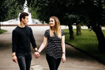 Young happy couple walking in park