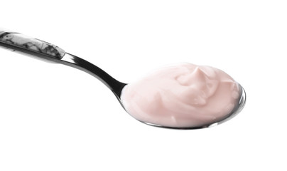 Spoon with tasty yogurt on white background