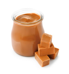 Jar with sweet liquid caramel on white background