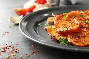 Plate with tasty sweet potato chips table, closeup