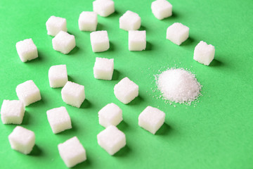 Sugar sand and cubes on color background. Concept of uniqueness