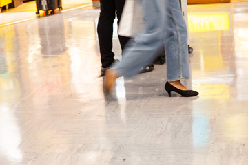 Business people walking in train station blur motion.