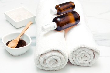White towels,bottles with oil,coffee scrub.Wellness therapy