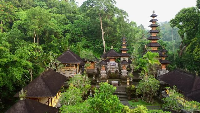 Buddhist Pura Gunung Lebah temple in Ubud tropical forest. Aerial drone 4k footage.