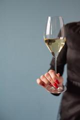 Woman holding a wine glass with wine in hand. Copy space