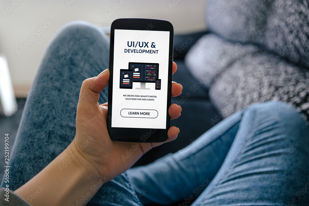 Sticker girl holding smart phone with ui/ux design and development concept on screen